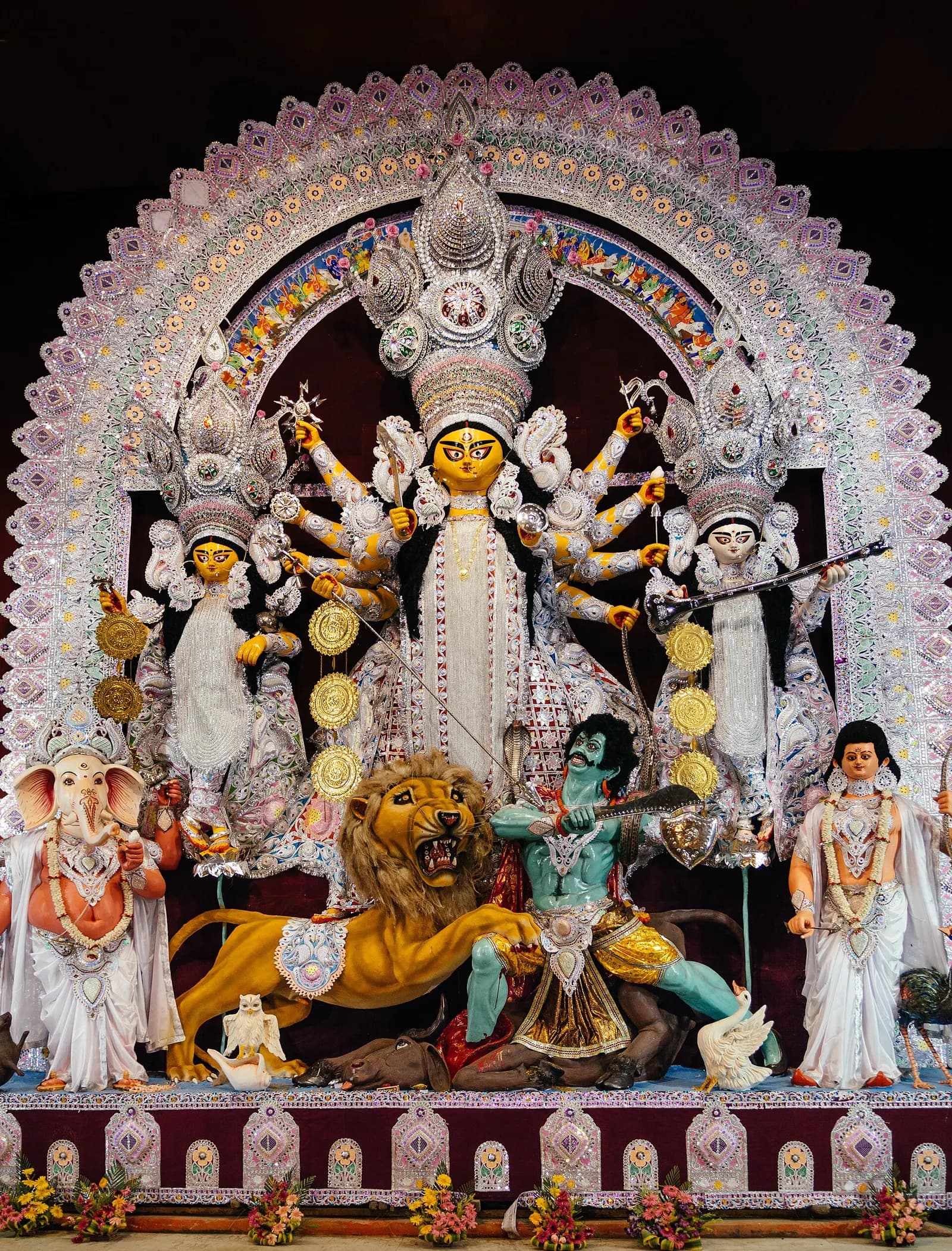 A decorated Durga idol lit inside a community pandal during Durga Puja in Kolkata