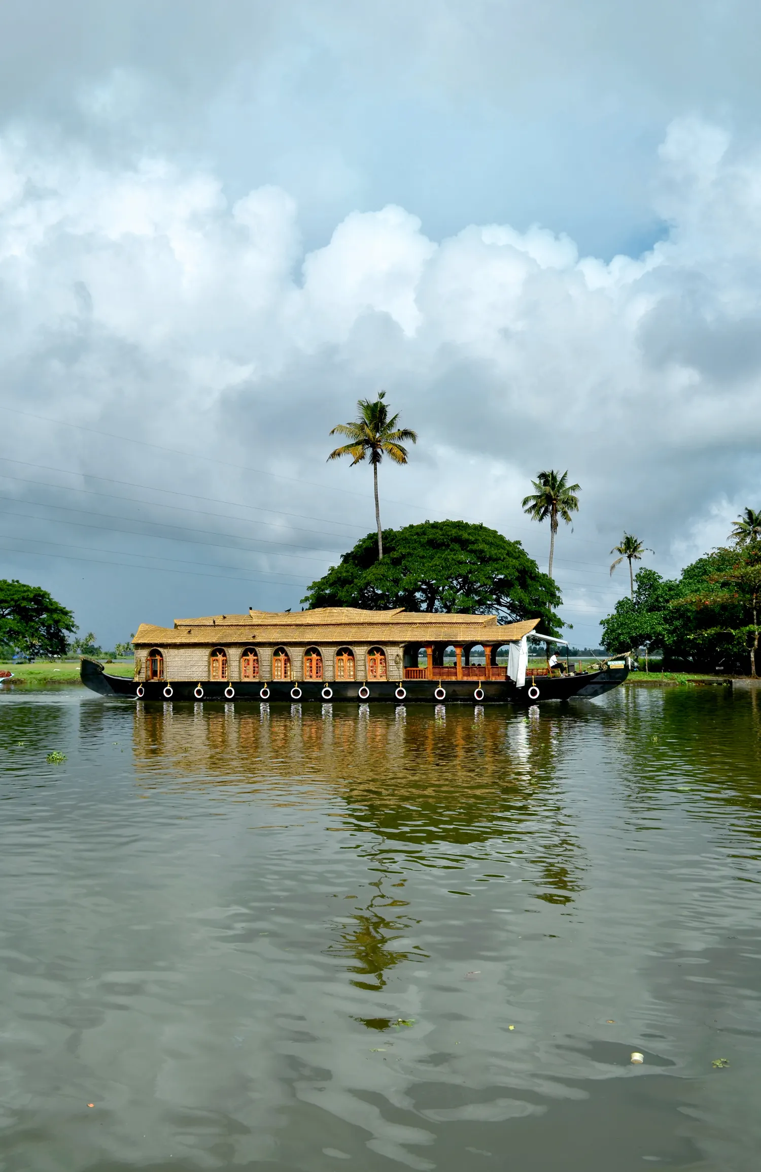A kettuvallam houseboat on the palm-lined backwaters at Alappuzha in Kerala