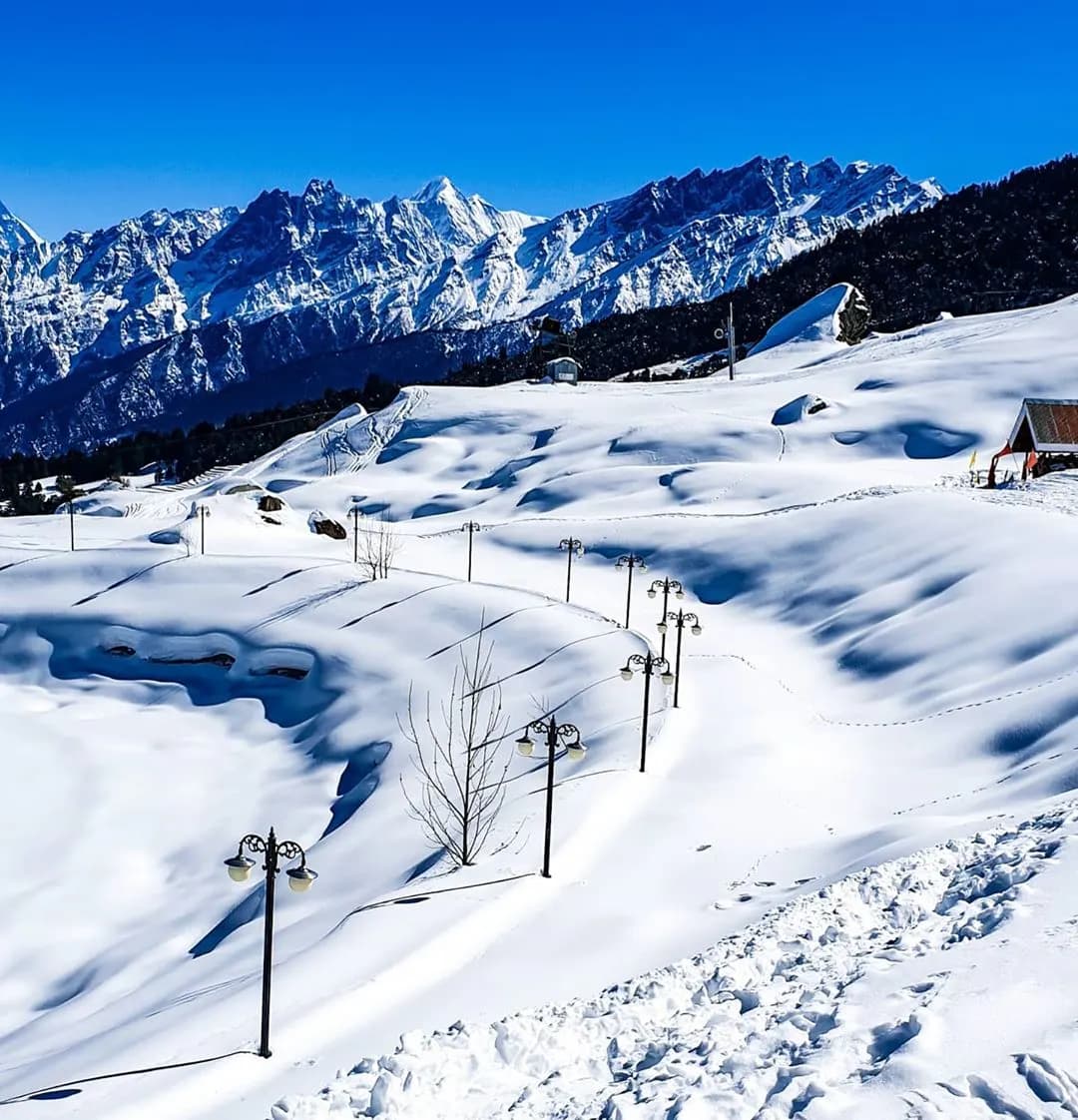 Snow-covered ski slopes of Auli with the Nanda Devi range on the horizon