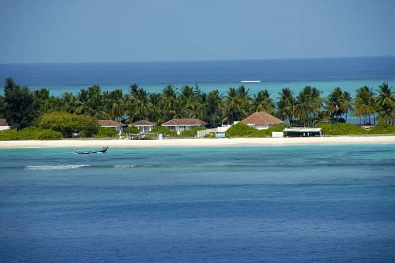Palm-fringed sand and a shallow turquoise lagoon on a Lakshadweep coral island