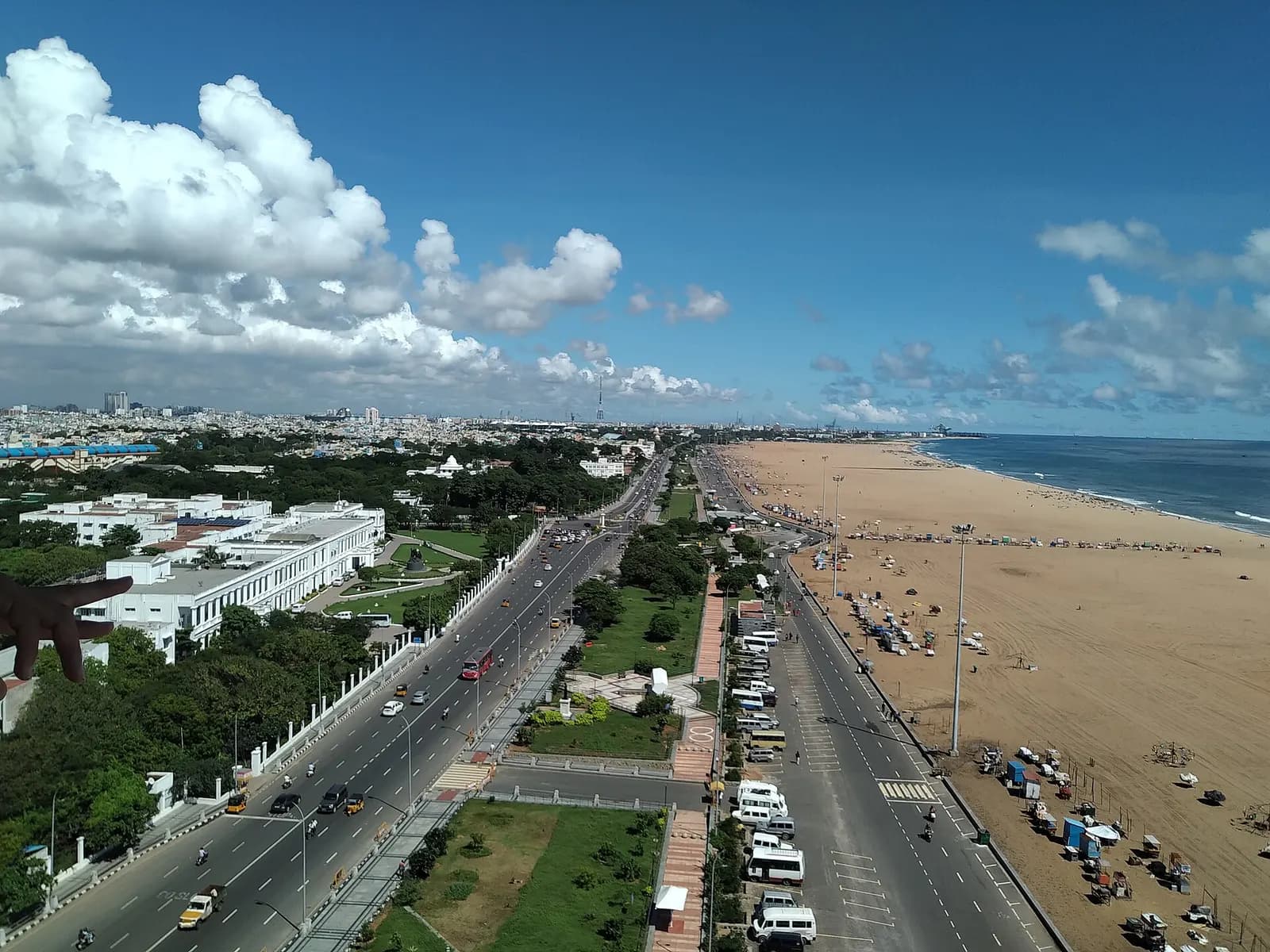Fishing boats and early morning walkers on the wide sands of Marina Beach in Chennai