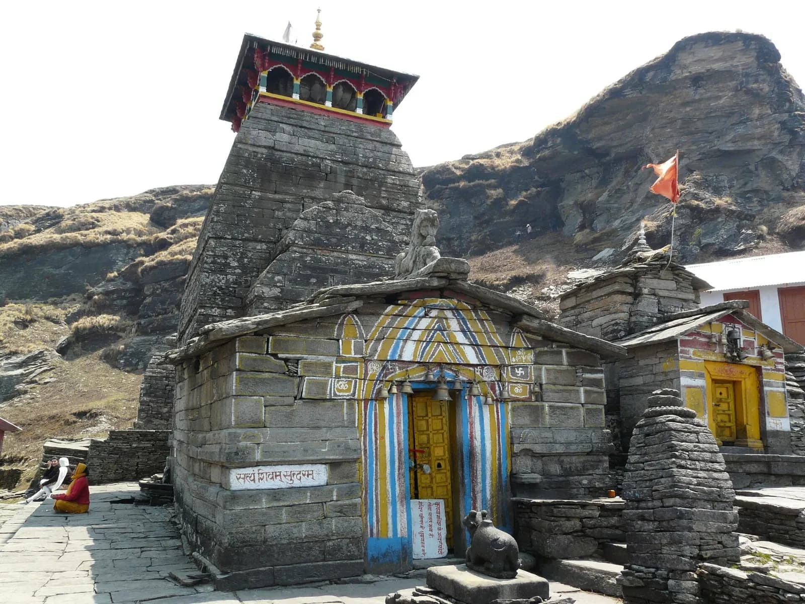 Tungnath stone temple on its ridge above Chopta with snow peaks beyond