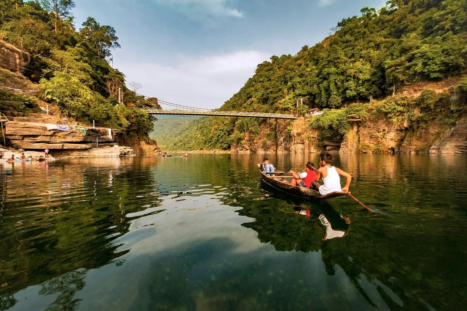 Wooden boats appearing to float over the crystal-clear Umngot river at Dawki, Meghalaya