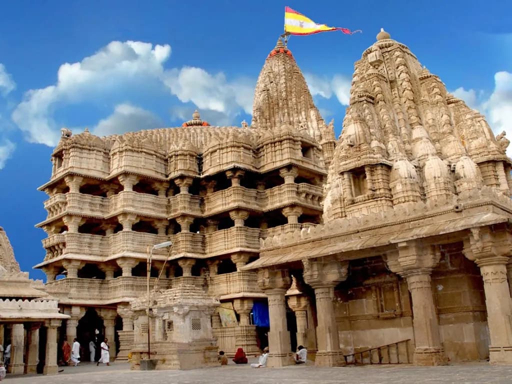 The five-storey Dwarkadhish temple with its tall flag above the Gomti ghat at Dwarka