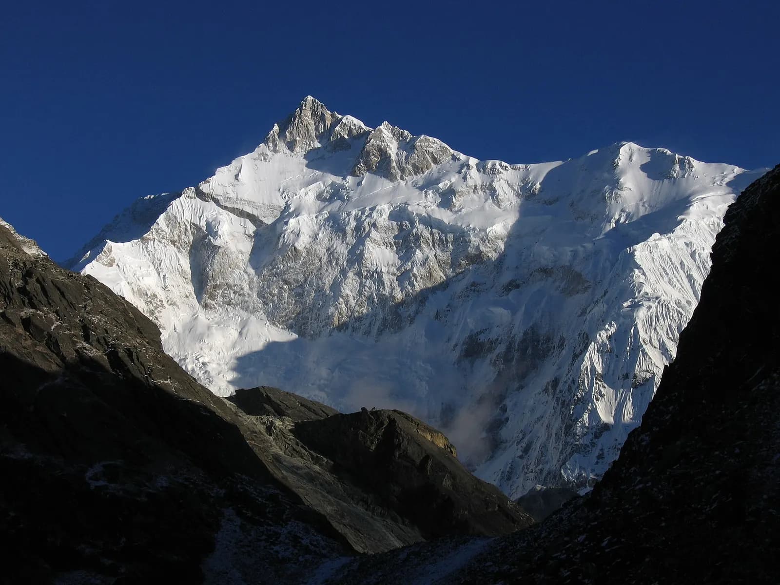 Gangtok's houses stacked along its ridge in Sikkim with mountains behind