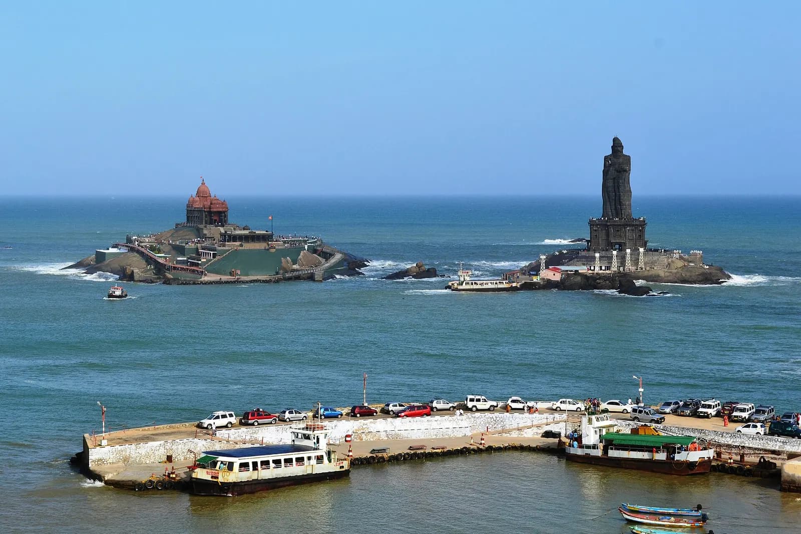 The Vivekananda Rock Memorial and Thiruvalluvar statue on rocky islets off Kanyakumari at sunrise