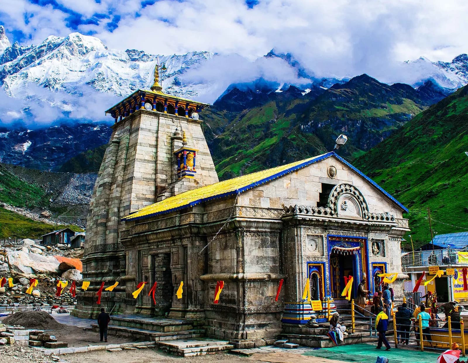Kedarnath stone temple with snow-covered Kedar Dome rising behind it