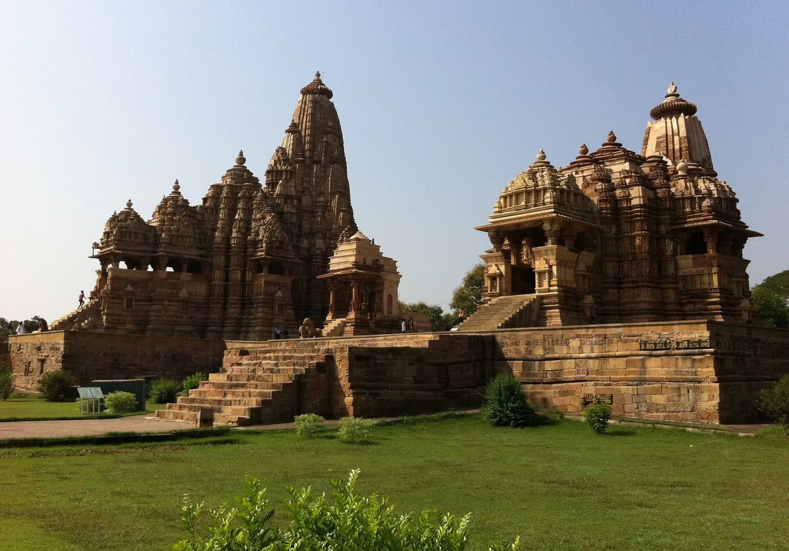 Kandariya Mahadeva temple at Khajuraho with its clustered sandstone spires against a blue sky