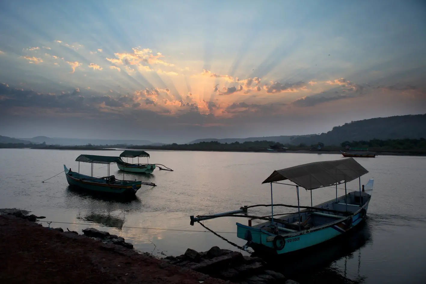 Clear shallow water and fishing boats on the beach at Tarkarli on the Konkan coast