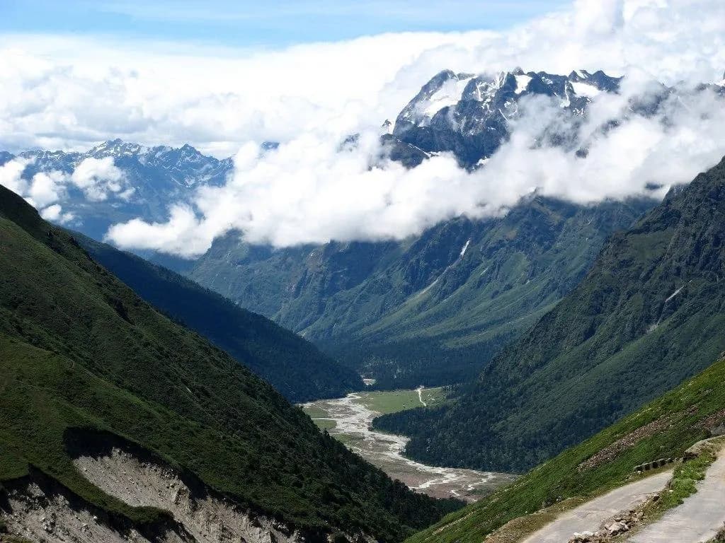The green floor of Yumthang Valley in North Sikkim below snow-covered ridges