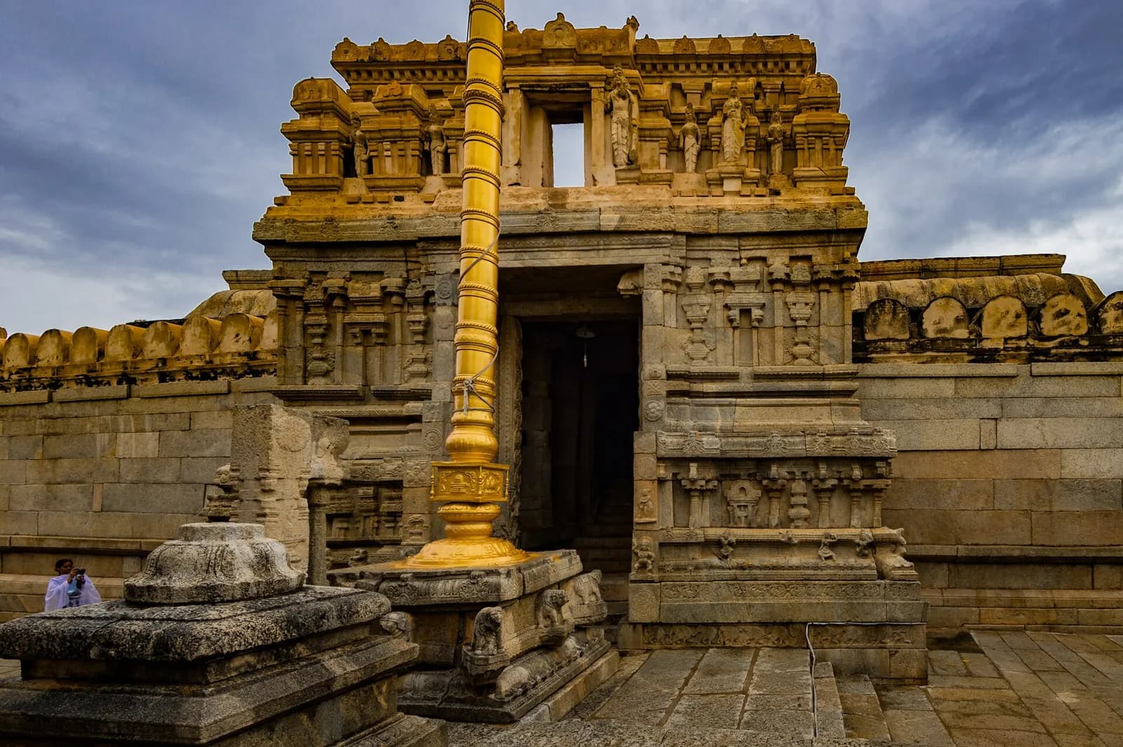 Carved granite pillars of the Veerabhadra Temple at Lepakshi with painted Vijayanagara ceiling murals