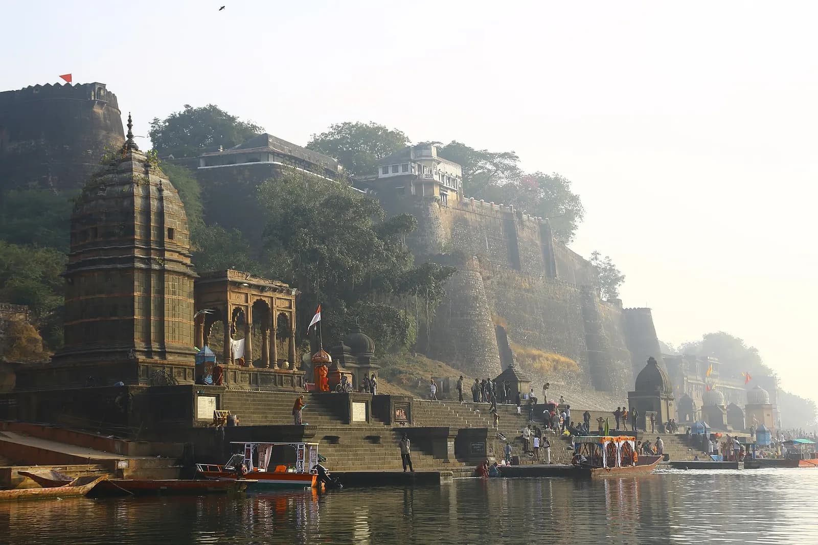 The ghats and fort walls of Maheshwar rising from the Narmada river at dusk