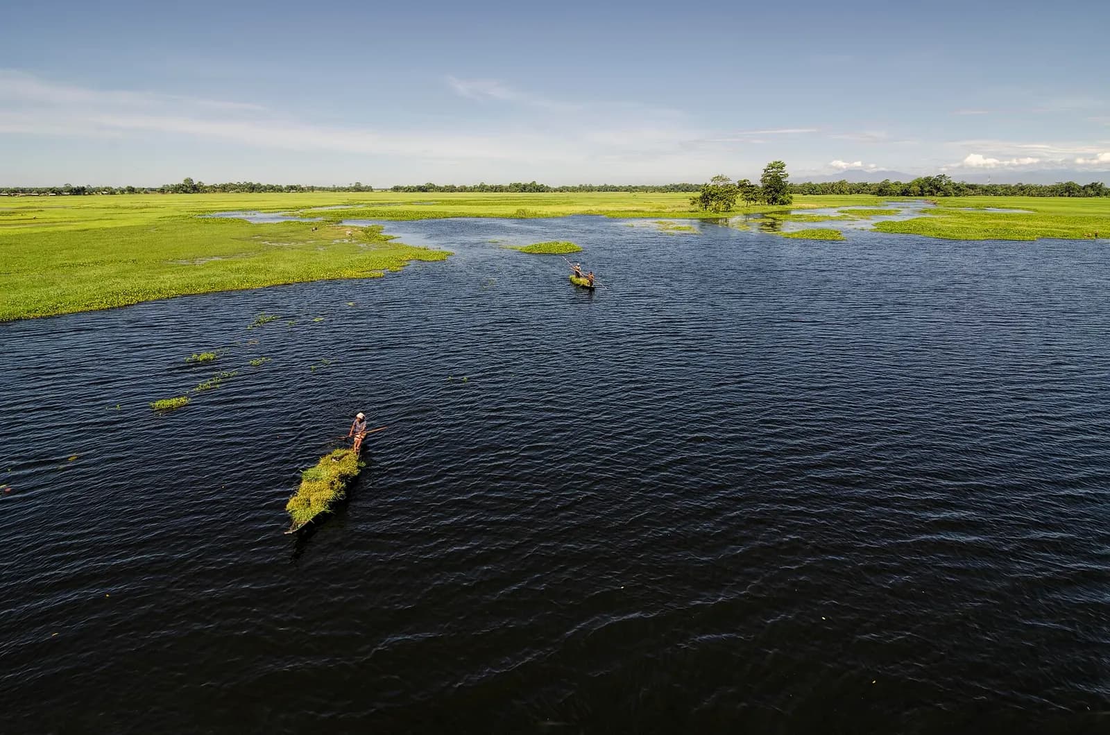 Wooden boats and sandbanks on the Brahmaputra at Majuli river island, Assam