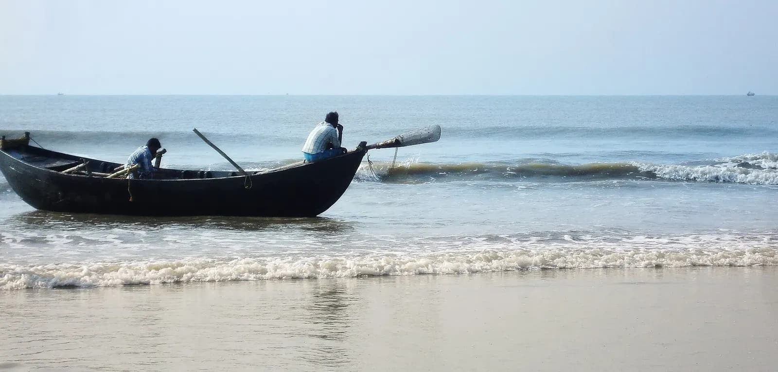 The wide sand and shallow surf of Mandarmani sea beach on the Bay of Bengal in West Bengal