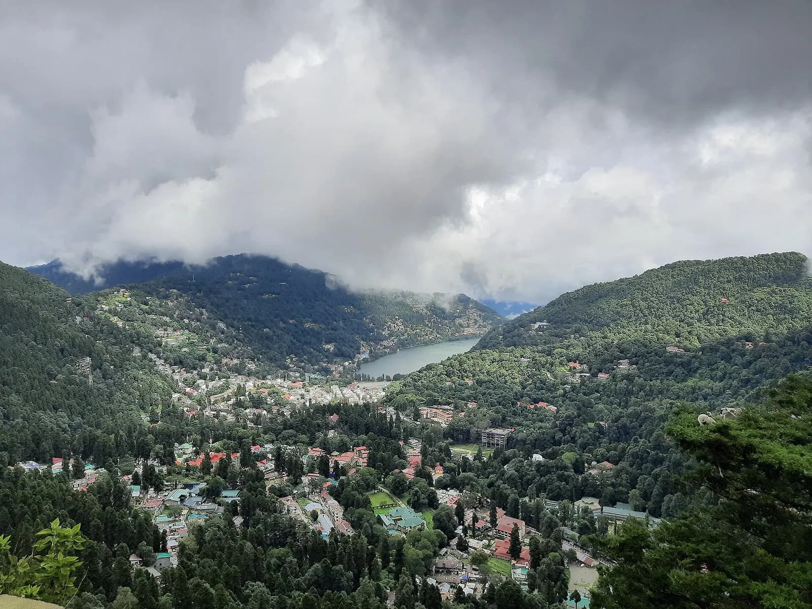 Naini Lake in Nainital ringed by hills and colonial-era buildings