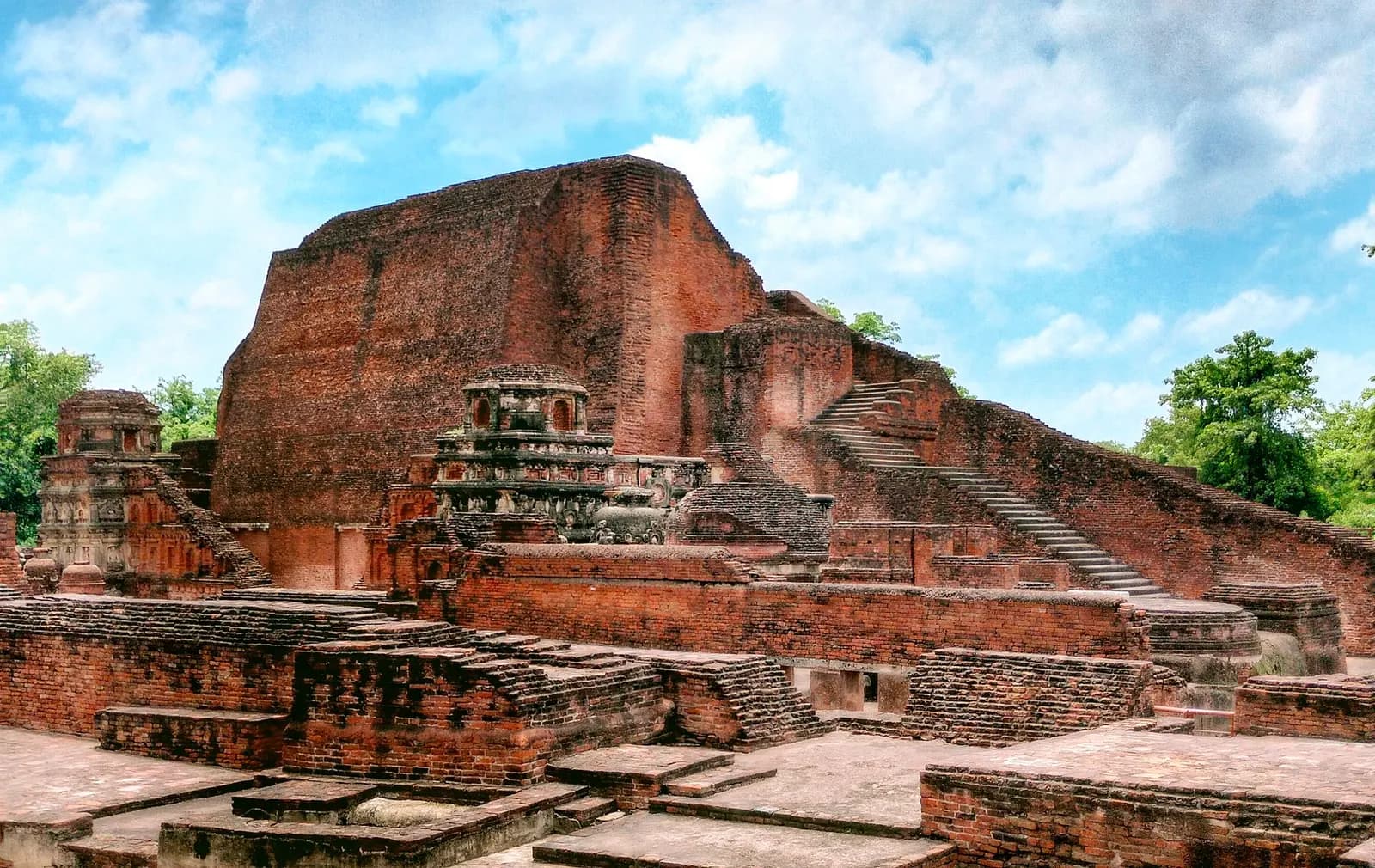 Red-brick monastery ruins and the tiered stupa of Sariputta at the Nalanda Mahavihara site