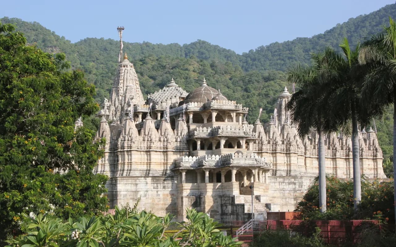 Carved white marble pillars and domed ceiling inside Ranakpur's Chaumukha Jain temple