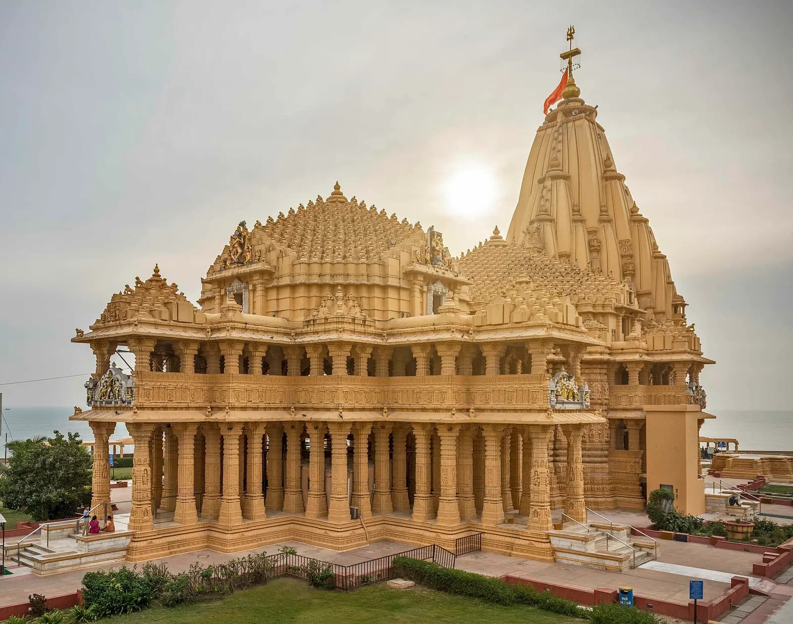 The Somnath temple in pale sandstone standing above the rocky Arabian Sea shore in Gujarat