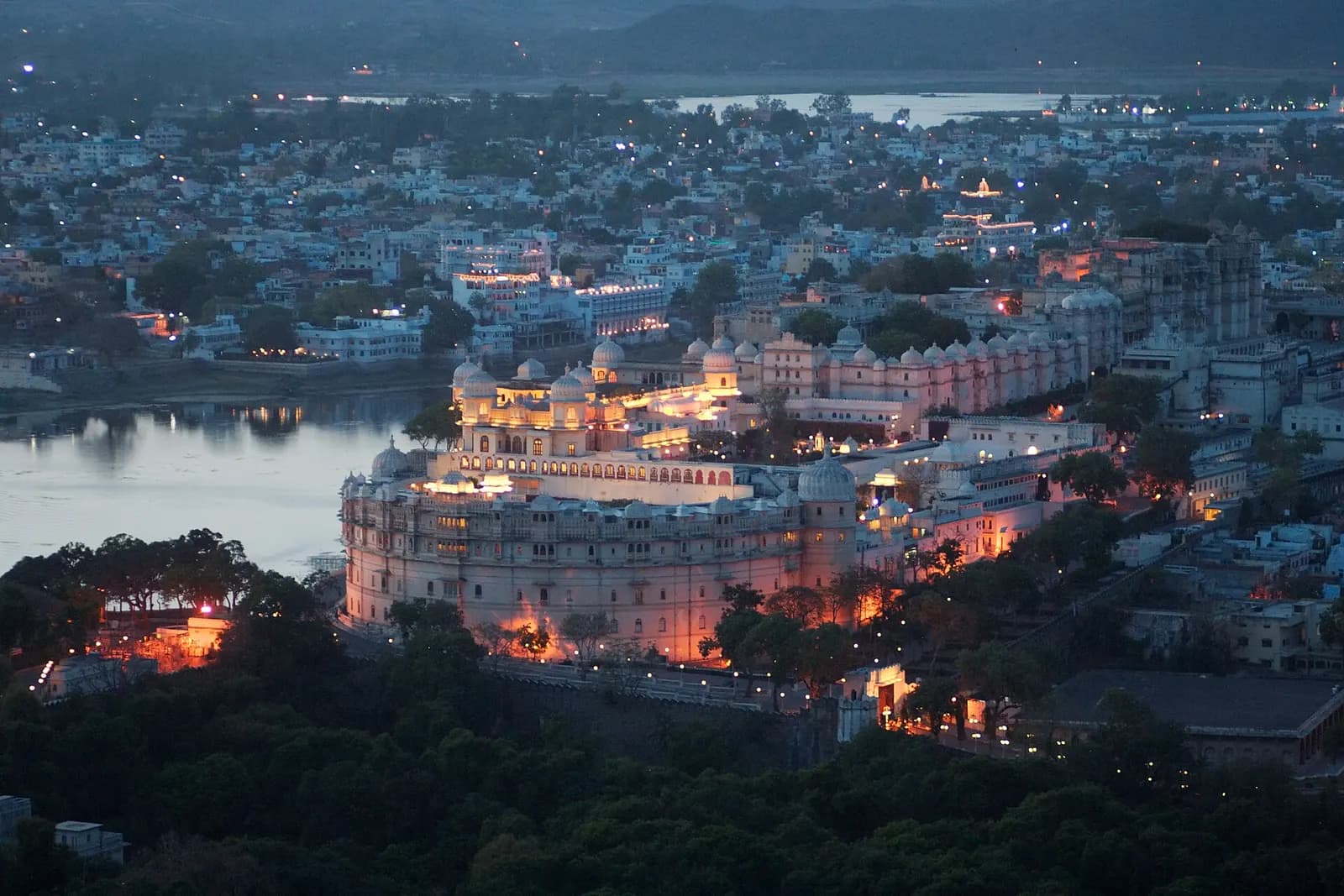 Udaipur's City Palace and Lake Pichola seen across the water at golden hour