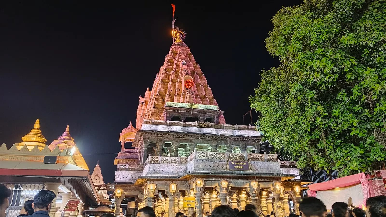 The spire of the Mahakaleshwar Jyotirlinga temple in Ujjain rising above pilgrims