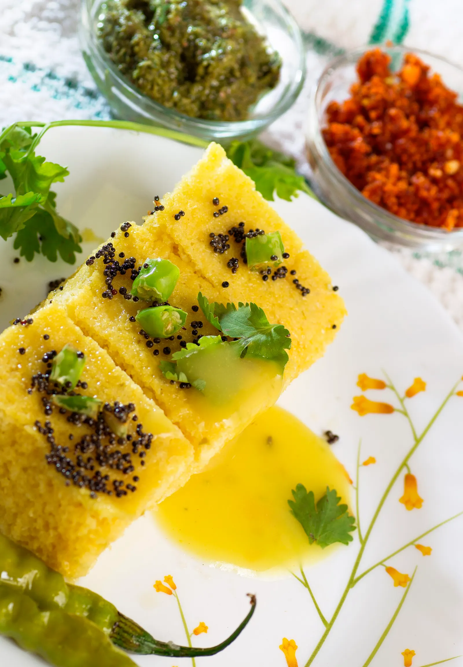 Squares of Gujarati khaman dhokla with tempering and coriander