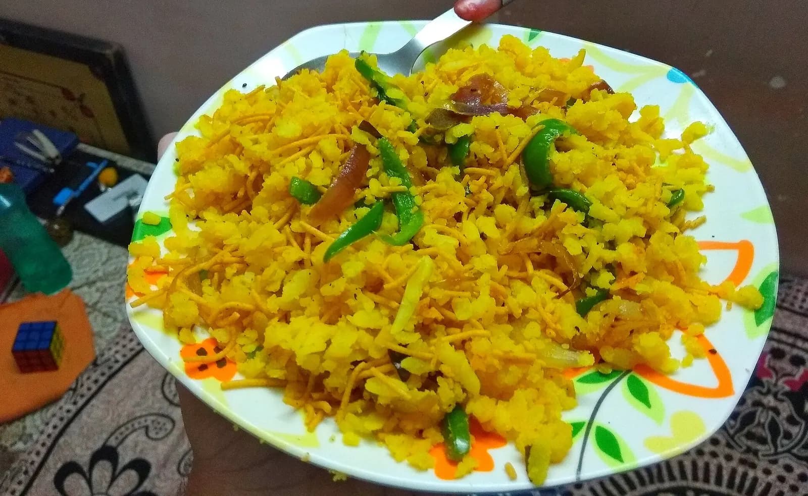 A plate of Indori poha topped with sev and onion