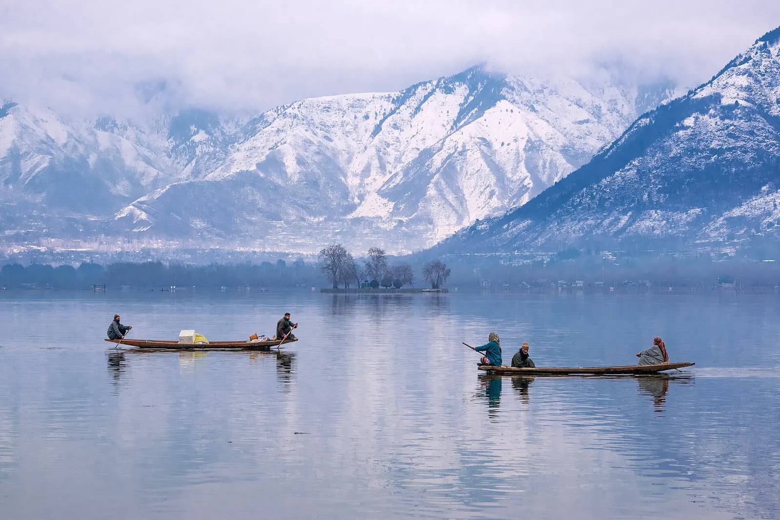 Shikaras moored on Dal Lake at Srinagar with mountains behind